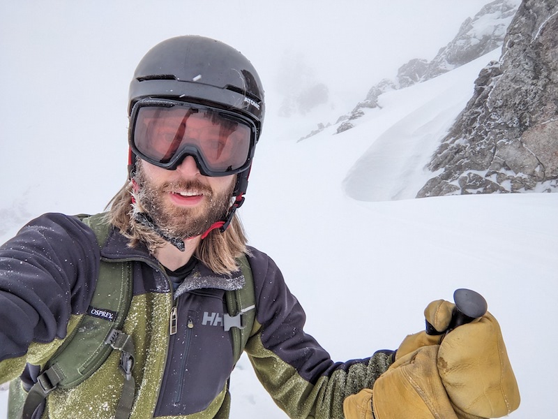a photo of me smiling in the snows at the top of the nordkette. there is snow and ice in my hair and beard. snow everywhere.